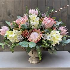 Protea and orchid arrangement 