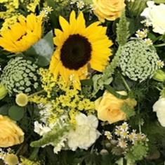 A Florist choice Yellow and White Casket spray