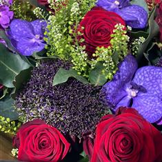 A florist choice Purple and Dark Red Casket spray