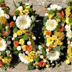 Loose mum in yellow oranges and white